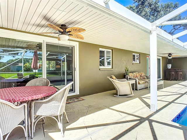 view of patio / terrace featuring glass enclosure and ceiling fan