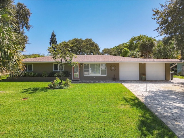 ranch-style home with a front lawn and a garage