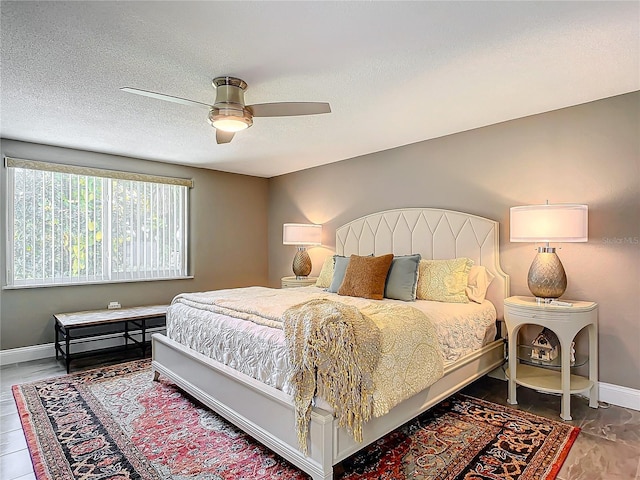 bedroom featuring a textured ceiling and ceiling fan