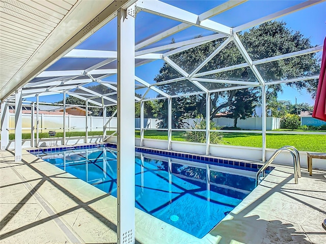 view of swimming pool featuring a yard, glass enclosure, and a patio area