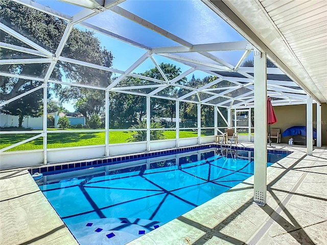 view of pool featuring glass enclosure and a patio area