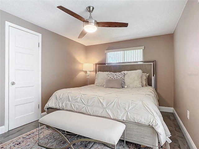 bedroom with ceiling fan and wood-type flooring