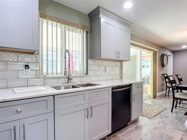 kitchen with gray cabinetry, sink, and black dishwasher