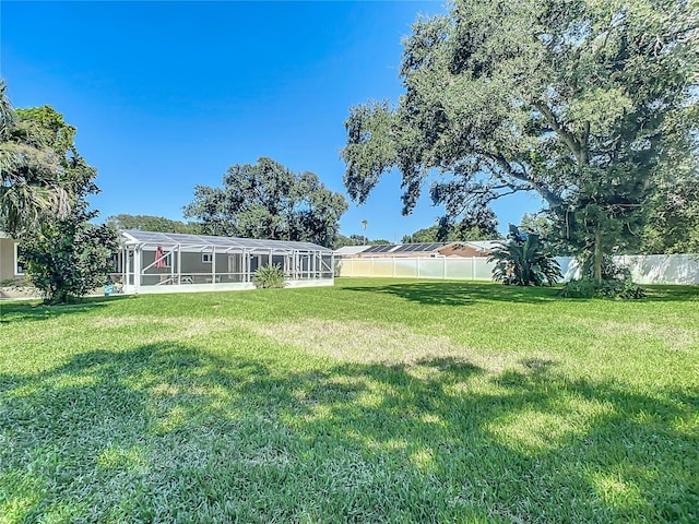 view of yard with a lanai