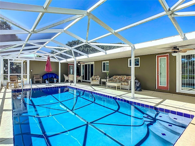 view of pool with ceiling fan, a lanai, and a patio