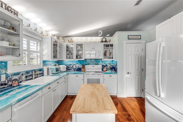 kitchen featuring white appliances, wood counters, dark wood-type flooring, and white cabinets