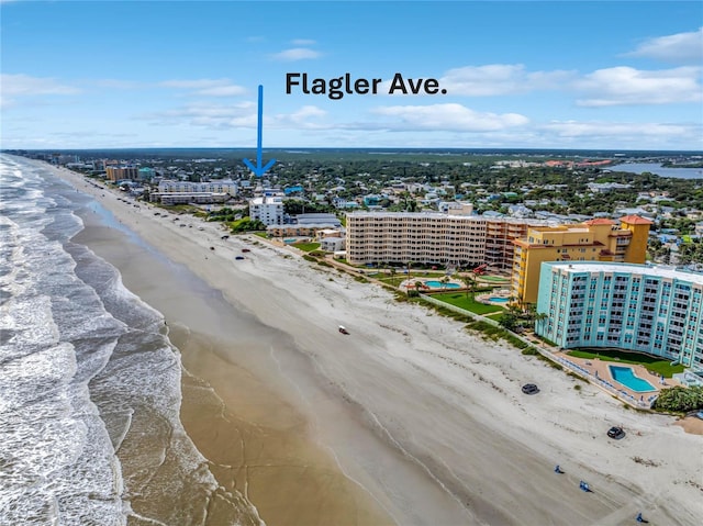 aerial view with a water view and a beach view