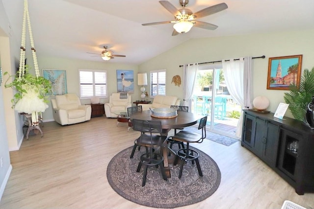 dining room featuring ceiling fan, light hardwood / wood-style flooring, vaulted ceiling, and a healthy amount of sunlight