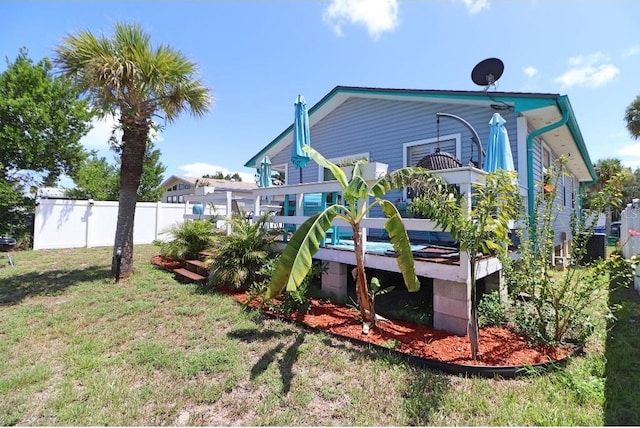 rear view of house featuring a yard