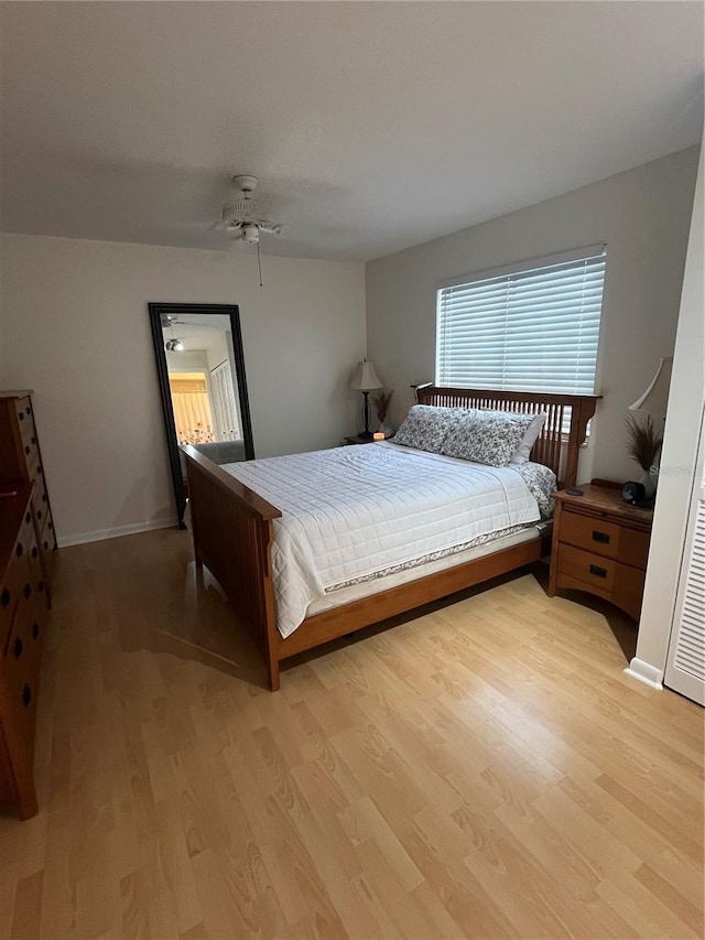 bedroom with light hardwood / wood-style flooring and ceiling fan