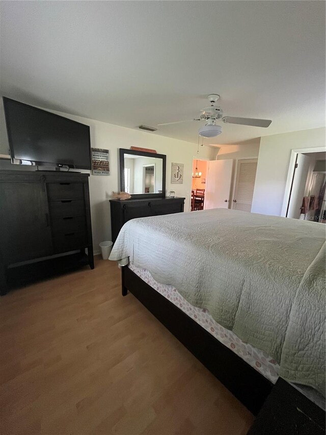 bedroom with hardwood / wood-style floors and ceiling fan