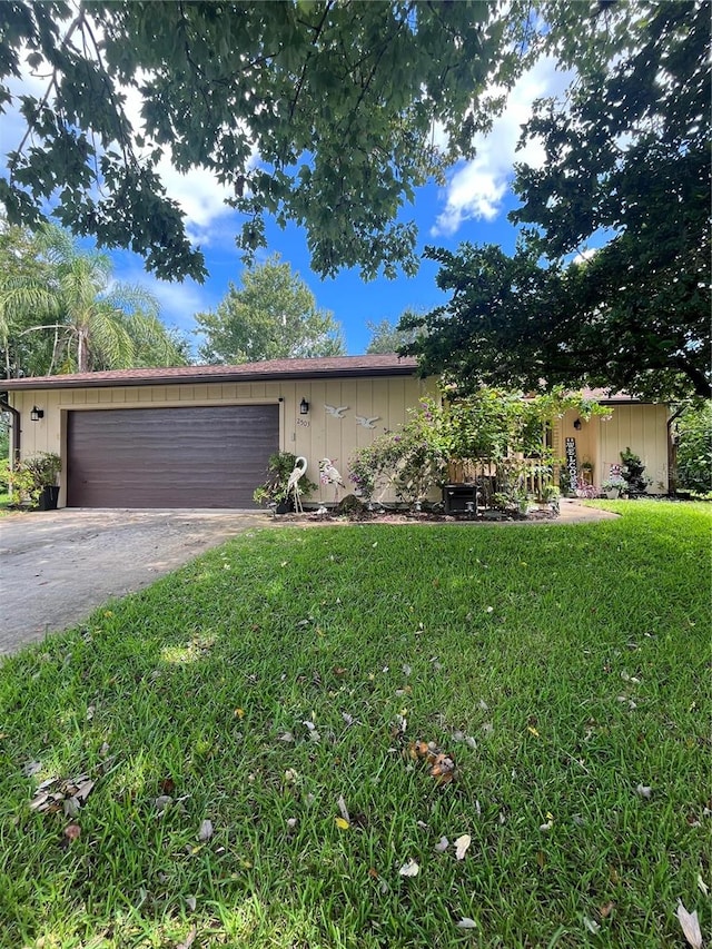 ranch-style house with a garage and a front yard