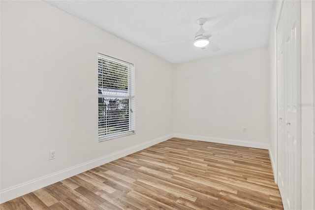 spare room featuring light wood-type flooring and ceiling fan