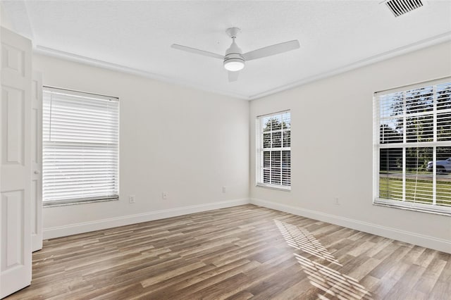 unfurnished room with a textured ceiling, ceiling fan, and hardwood / wood-style flooring