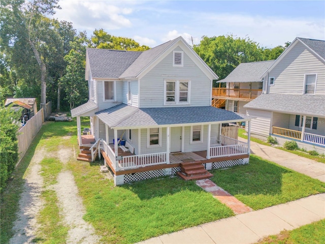 view of front of house with a front yard and covered porch