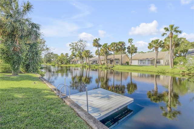 dock area featuring a lawn and a water view