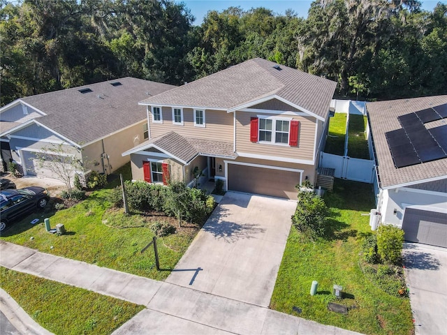 front of property featuring a front yard and a garage