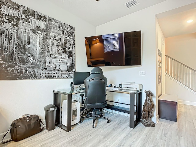 office featuring light hardwood / wood-style floors and lofted ceiling