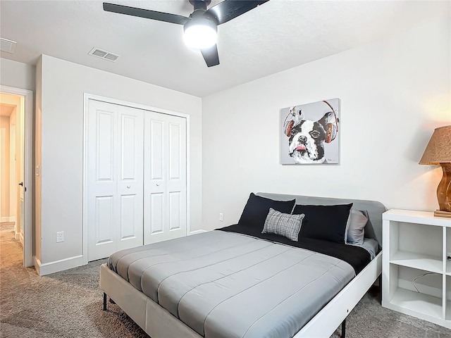 carpeted bedroom with a closet and ceiling fan