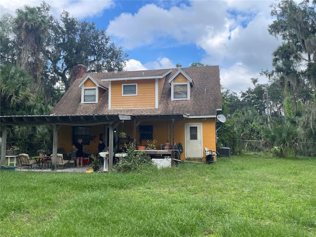 back of property with a lawn, a patio, and central air condition unit