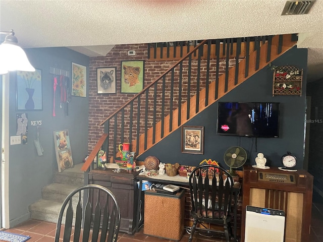 stairway featuring a textured ceiling and tile patterned floors