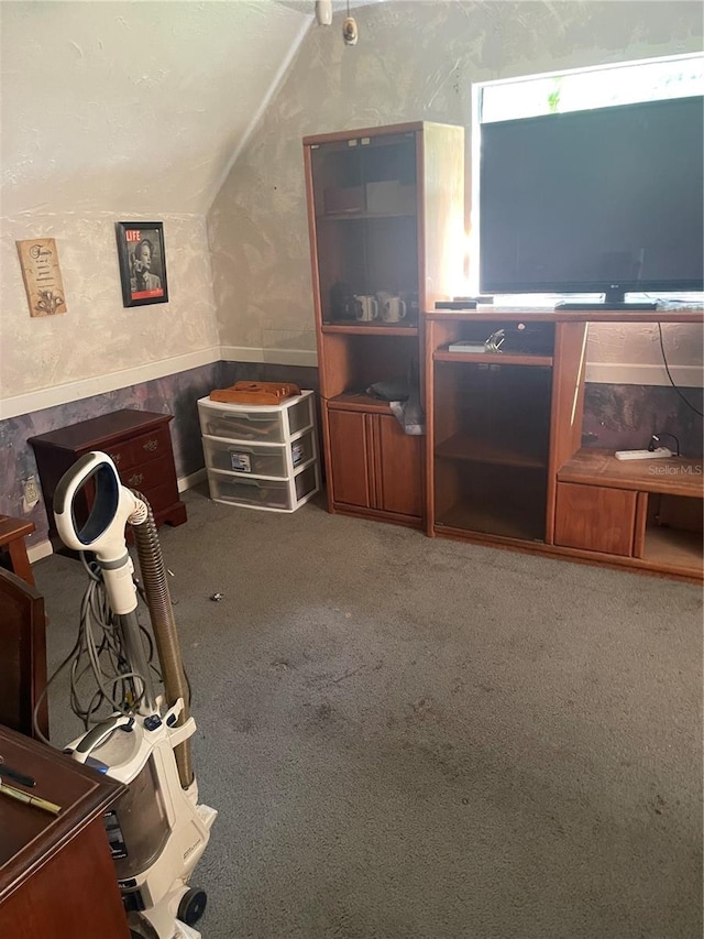 interior space featuring lofted ceiling and carpet floors