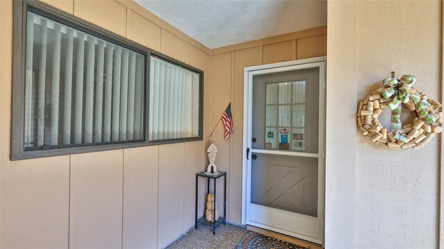 11 Andrea Dr, New Smyrna Beach, FL 32168 - doorway to property with board and batten siding