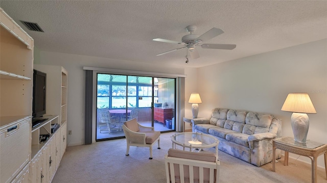 11 Andrea Dr, New Smyrna Beach, FL 32168 - living room with light carpet, a ceiling fan, and a textured ceiling