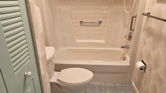 bathroom with tile patterned flooring, toilet, and tub / shower combination