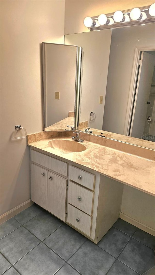 bathroom with tile patterned flooring and vanity