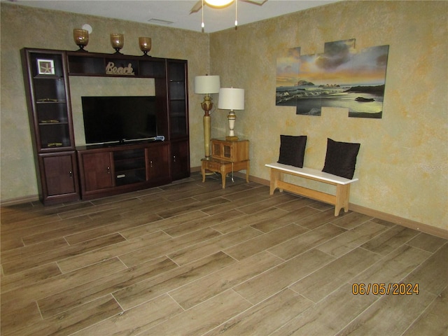 living room with wood-type flooring and ceiling fan