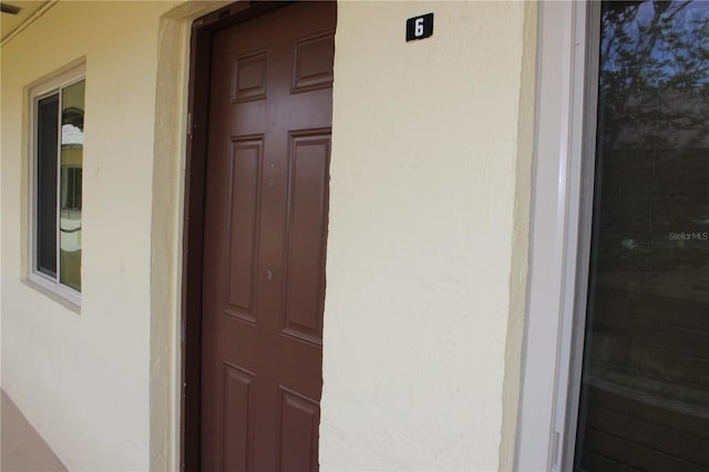 400 Oakridge Blvd Unit 6, Daytona Beach, FL 32118 - doorway to property with stucco siding