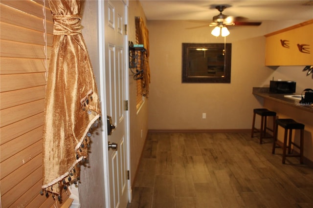 400 Oakridge Blvd Unit 6, Daytona Beach, FL 32118 - kitchen with baseboards, a ceiling fan, a breakfast bar area, and wood finished floors