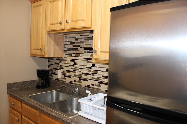 400 Oakridge Blvd Unit 6, Daytona Beach, FL 32118 - kitchen featuring freestanding refrigerator, a sink, dark countertops, and tasteful backsplash