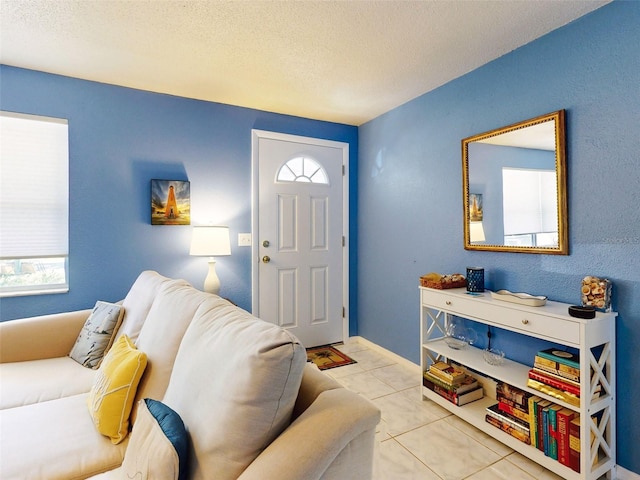 tiled entryway with a textured ceiling