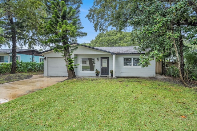 ranch-style house featuring a garage and a front lawn