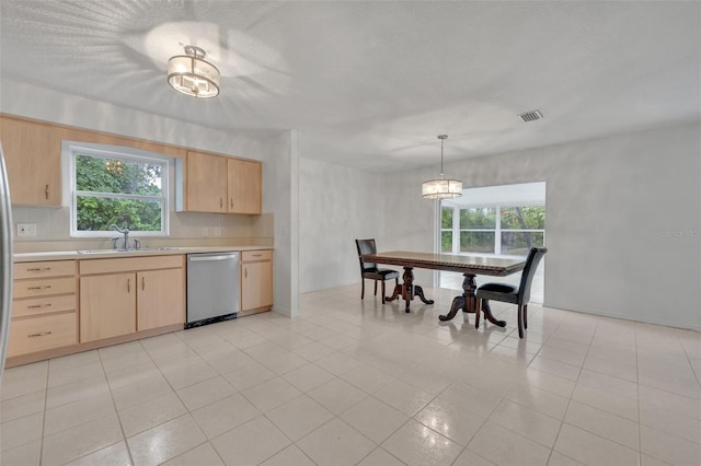 kitchen with pendant lighting, sink, stainless steel dishwasher, and light brown cabinets