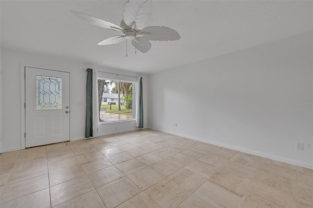 unfurnished room with light tile patterned floors and ceiling fan