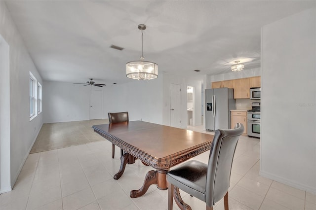 dining space with light tile patterned floors and ceiling fan