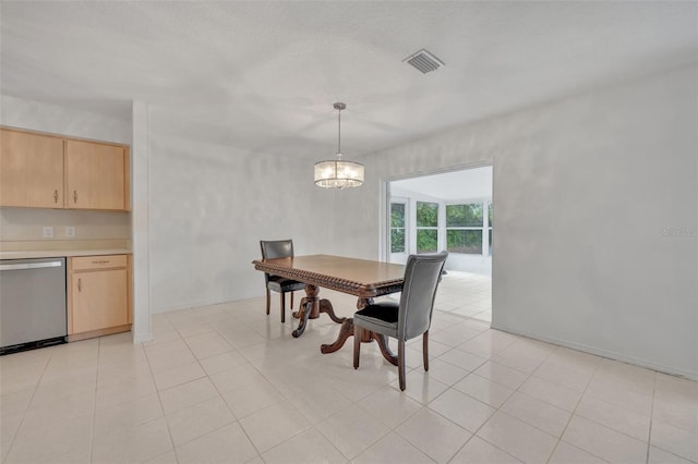 dining space featuring light tile patterned floors and a notable chandelier