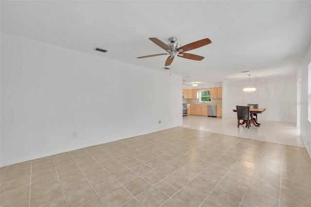 unfurnished living room with light tile patterned floors and ceiling fan