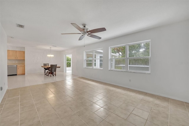 tiled spare room with ceiling fan