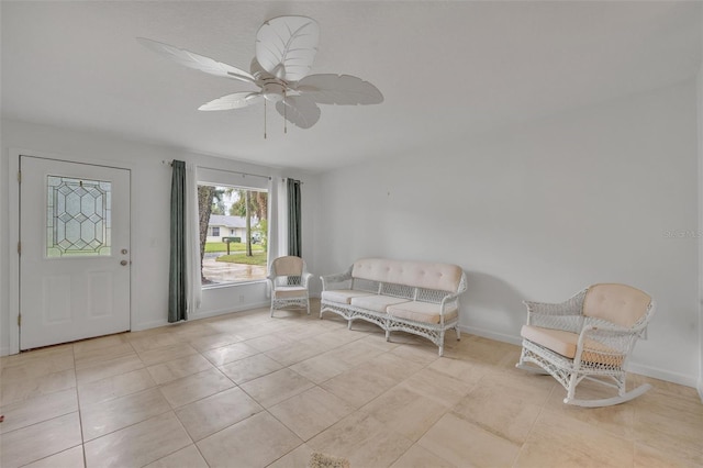 living area featuring light tile patterned floors and ceiling fan