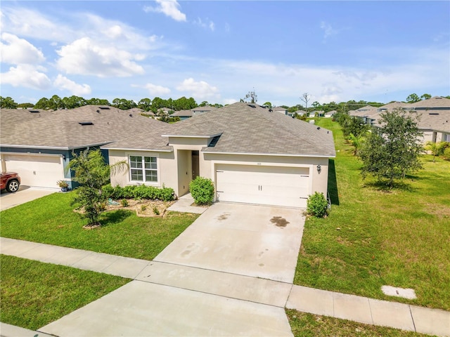 ranch-style home featuring a front lawn and a garage