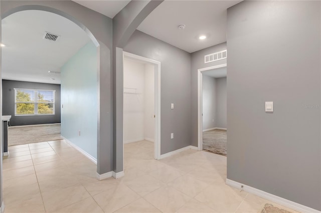 hallway with light colored carpet