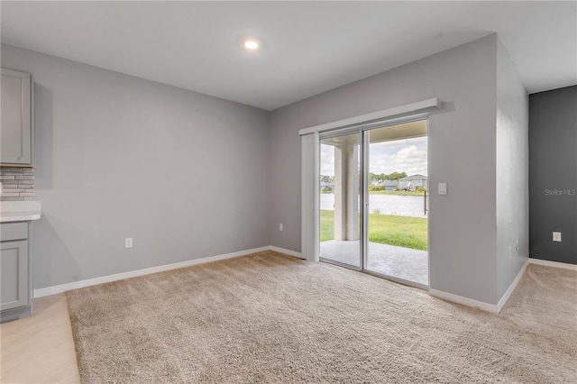 empty room featuring light colored carpet