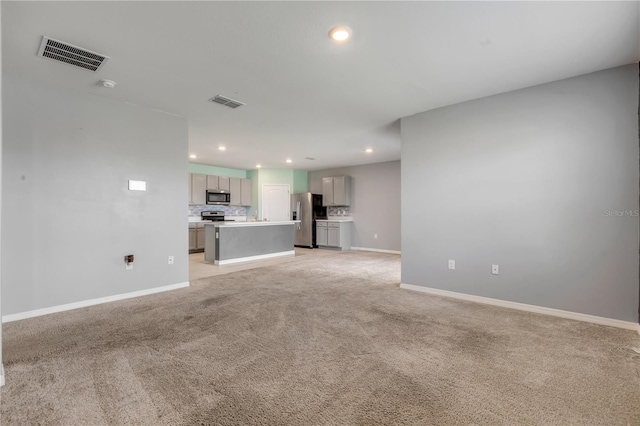 unfurnished living room featuring light colored carpet