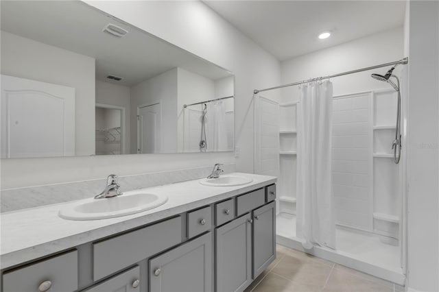 bathroom with tile patterned floors, vanity, and a shower with curtain