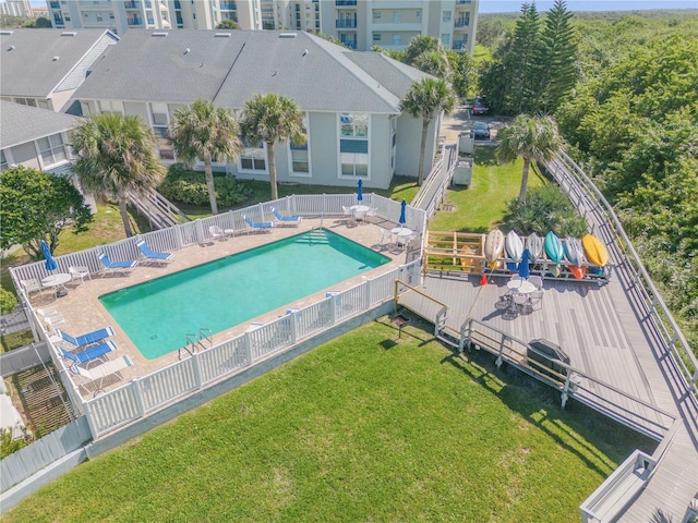 view of pool with a patio, a lawn, and a deck