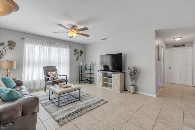 tiled living room with ceiling fan